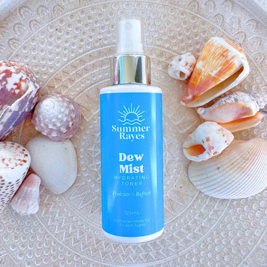 Summer Rayes Teen Skincare Dew Mist Hydrating Toner bottle surrounded by seashells on a textured surface