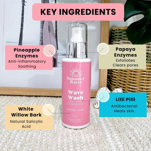 Pink bottle of Summer Rayes Wave Wash Enzyme Cleanser teen skincare with key ingredients labeled on a textured surface.