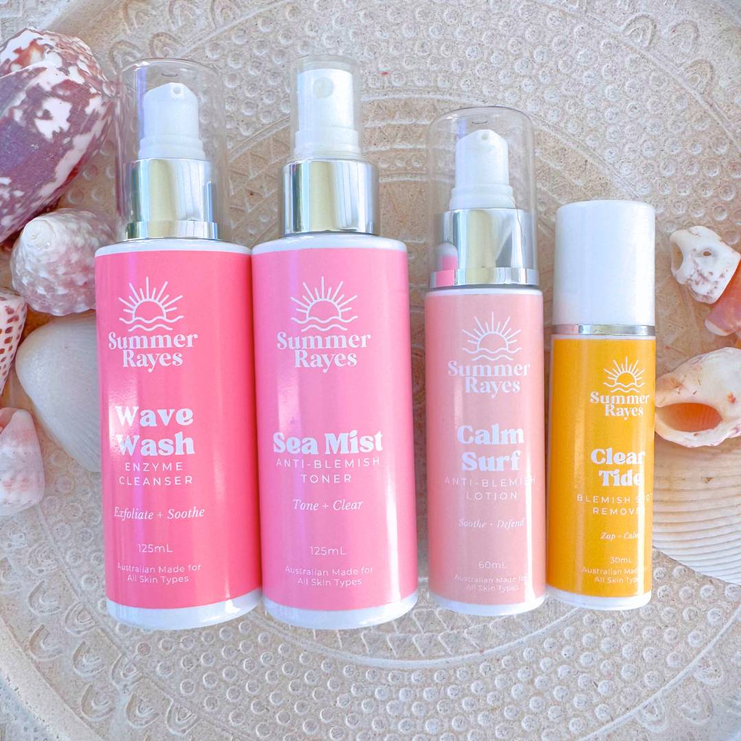 Four Summer Rayes teen skincare products on a textured surface with seashells - 4 step anti-blemish routine