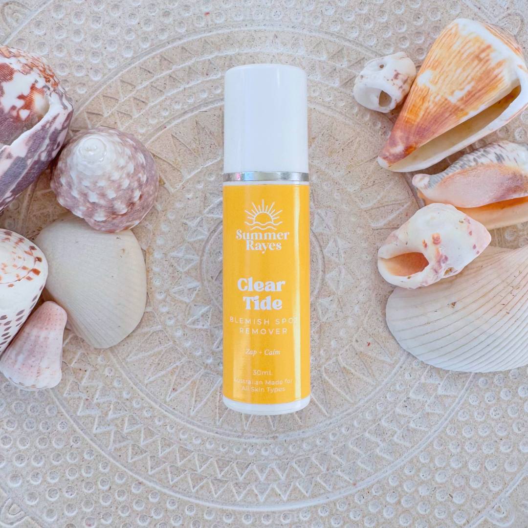 Bottle of 'Clear Tide' teen skincare product by Summer rayes on a textured surface with seashells.
