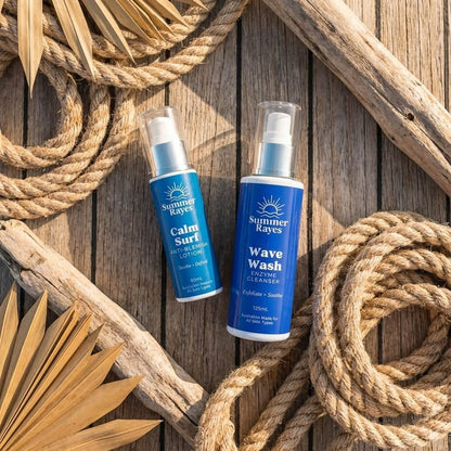 Two Summer Rayes surf-themed cleansing products, 'Calm Surf' and 'Wave Wash', arranged on a rustic wooden background with decorative rope and driftwood.