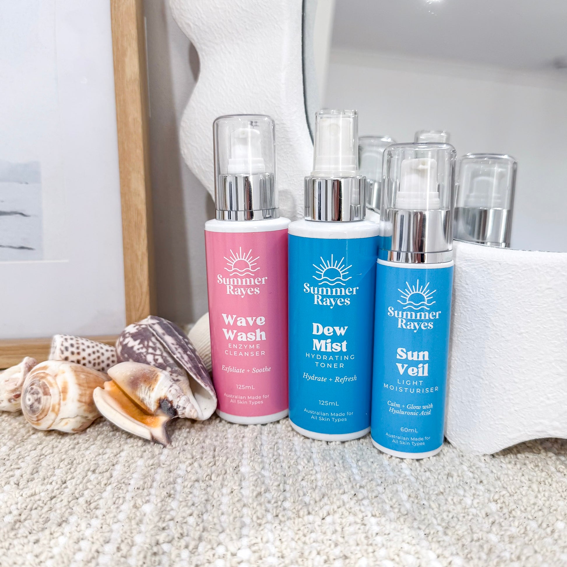 Three Summer Rayes teen skincare products on a textured surface with seashells.
