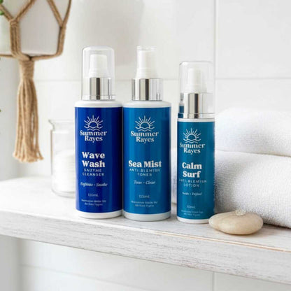 Three Summer Rayes teen skincare products on a shelf with a white towel and decorative item in the background.