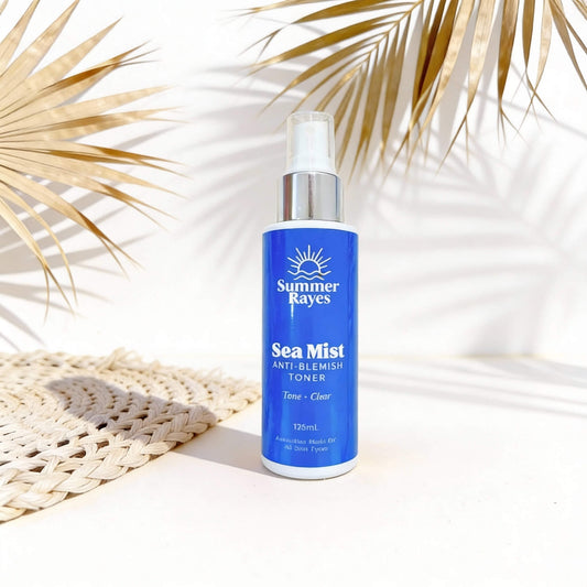 Summer Rayes Sea Mist toner bottle on a light background with palm leaves
