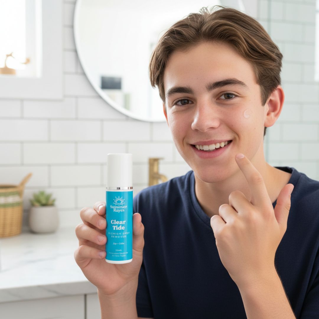 teenage boy holding a bottle of 'Clear Tide' skincare product in a bathroom setting