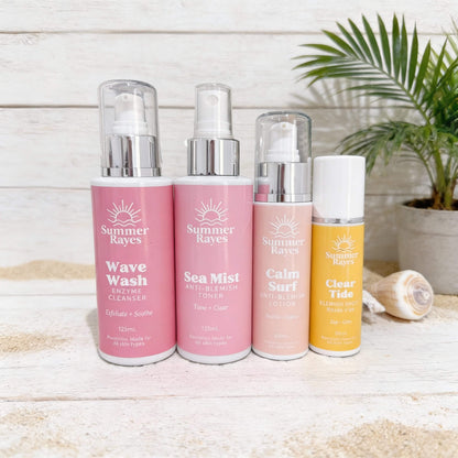 Four Summer Rayes skincare products on a wooden surface with a plant in the background