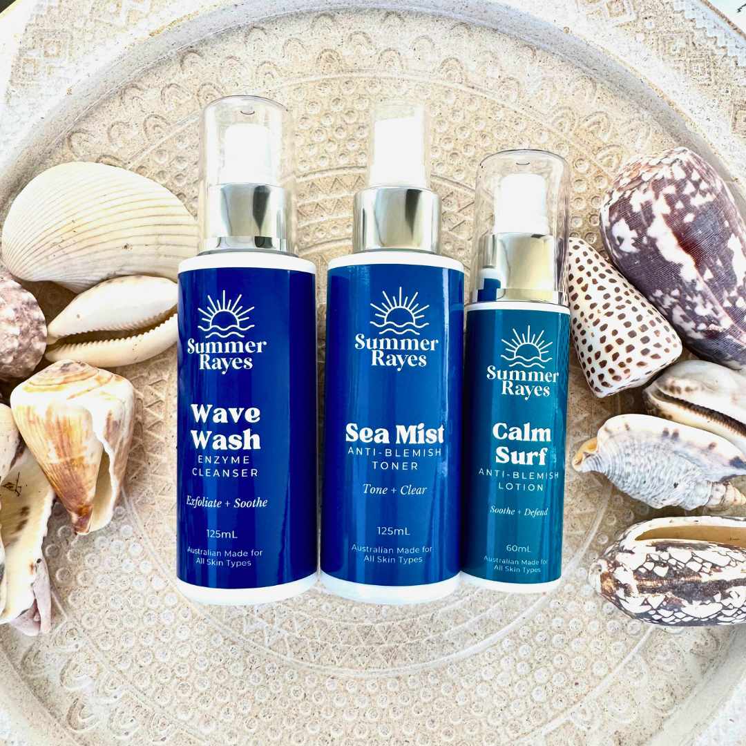 Three Summer Rayes skincare products on a decorative plate with seashells