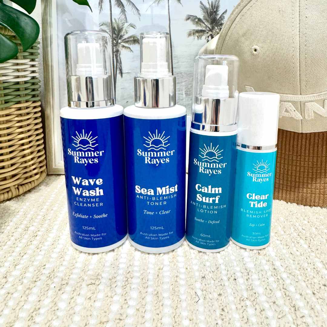 Four Summer Rayes skincare products on a textured surface with a blurred background