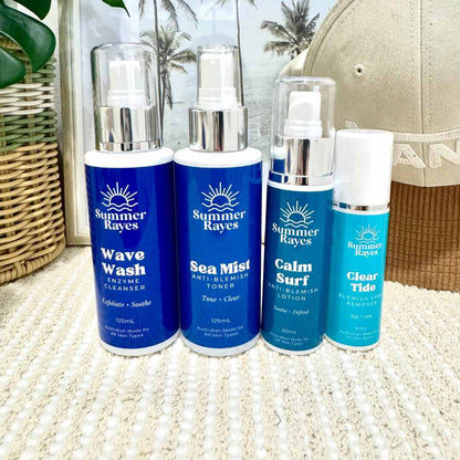 Four Summer Rayes skincare products on a textured surface with a blurred background