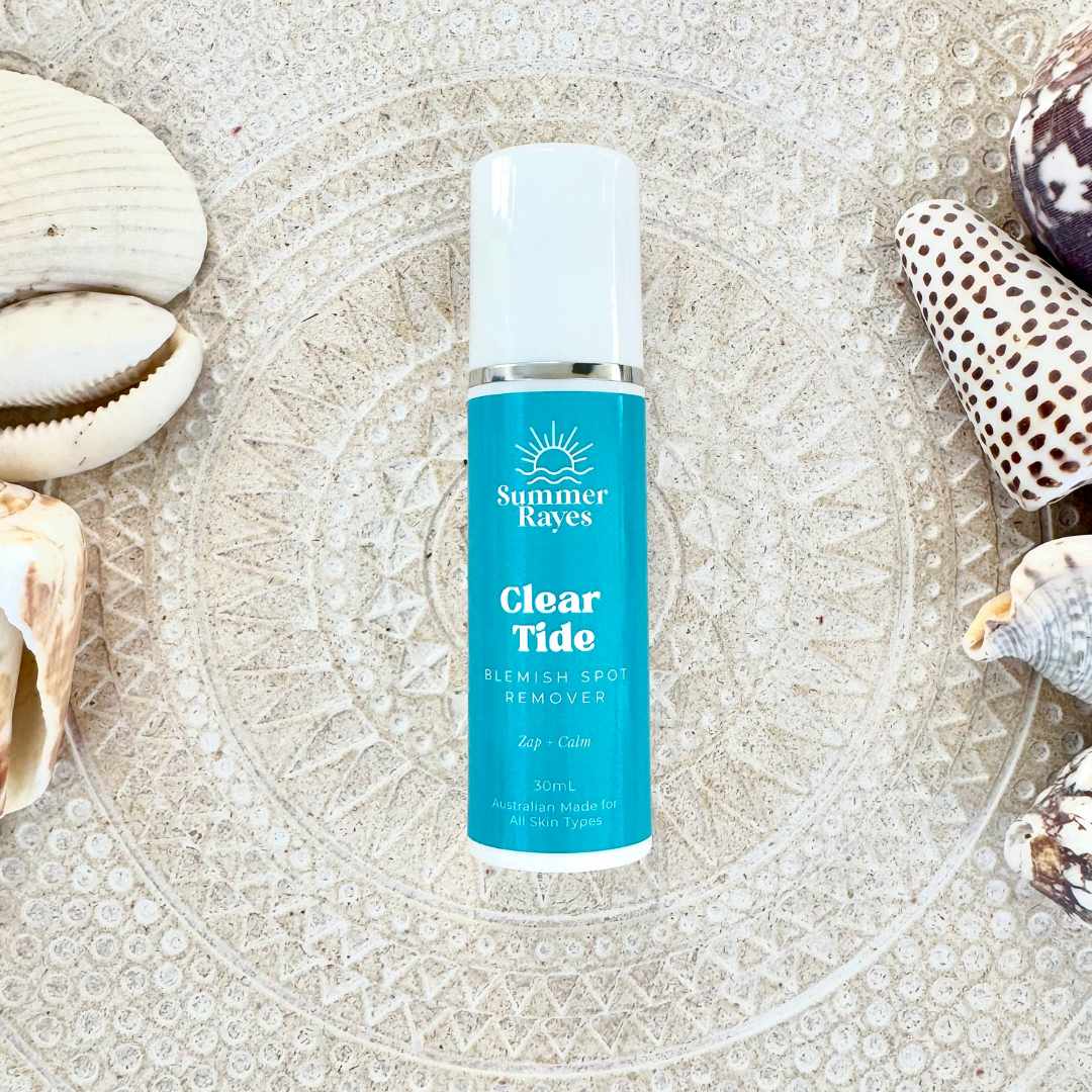 Bottle of Summer Rayes Clear Tide blemish spot remover on a textured surface with shells.
