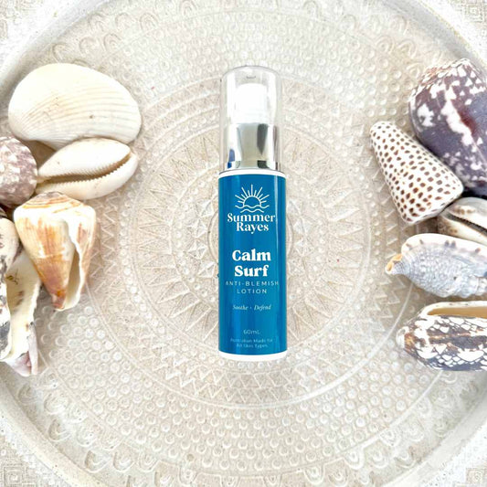 Summer Rayes Calm Surf lotion skincare for teen boys & girls bottle surrounded by seashells on a textured surface