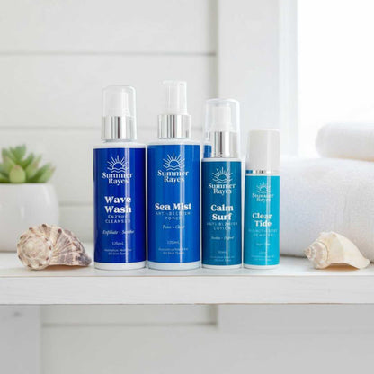 Four Summer Rayes teen skincare products on a white surface with shells and a plant in the background.