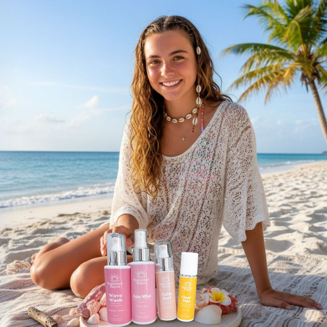 A teenage girl sitting on a beach with skincare products for teen skin