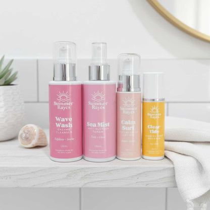 Four bottles of Summer Rayes teenage skincare products on a bathroom counter.